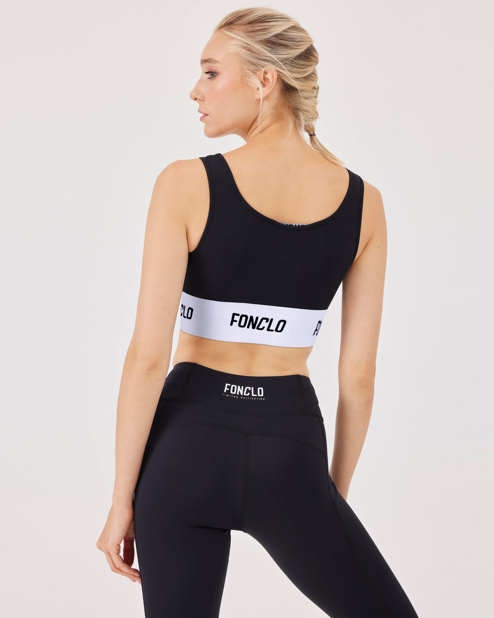 Black, ribbed, sports bra, elastic hem, elastic band adorned with fonclo logo, crop, top, sleeveless, stretchy, slim fit. 