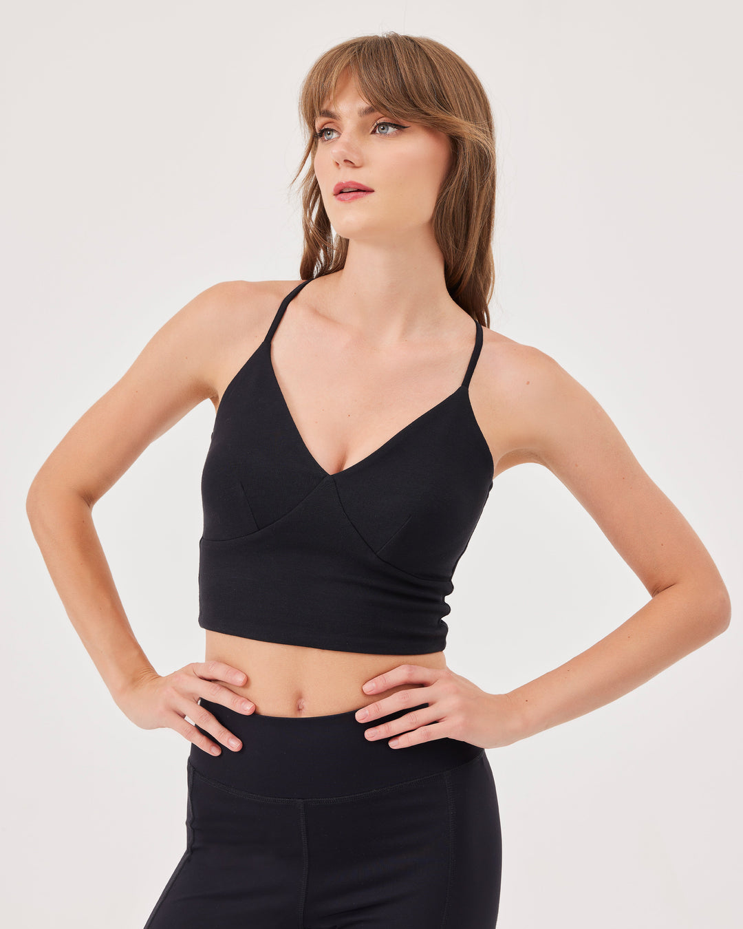 Black criss-cross strap sports bra, V-neckline, crossed straps at the back, fonclo logo on the back, high-quality, super-soft material, crop, strappy, slim fit.