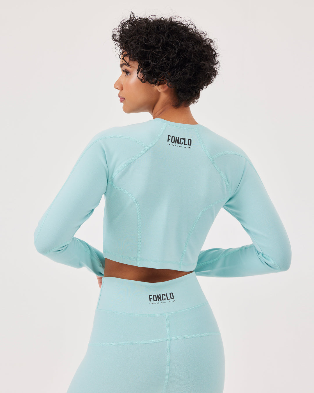 Blue, long sleeved crop top, raglan sleeves, thumb holes, round neck, slim fit, high-quality stretch fabric. 