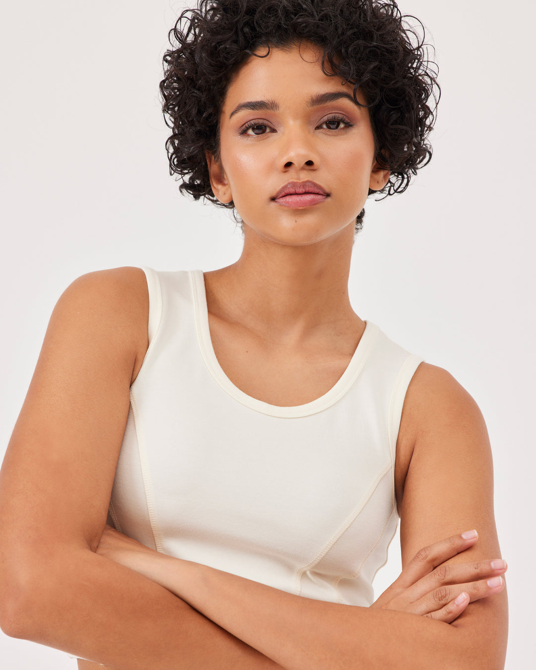 Beige basic tank top with wide straps and Fonclo logo on the back. Crop and round neckline. Perfect for activewear and everyday looks.