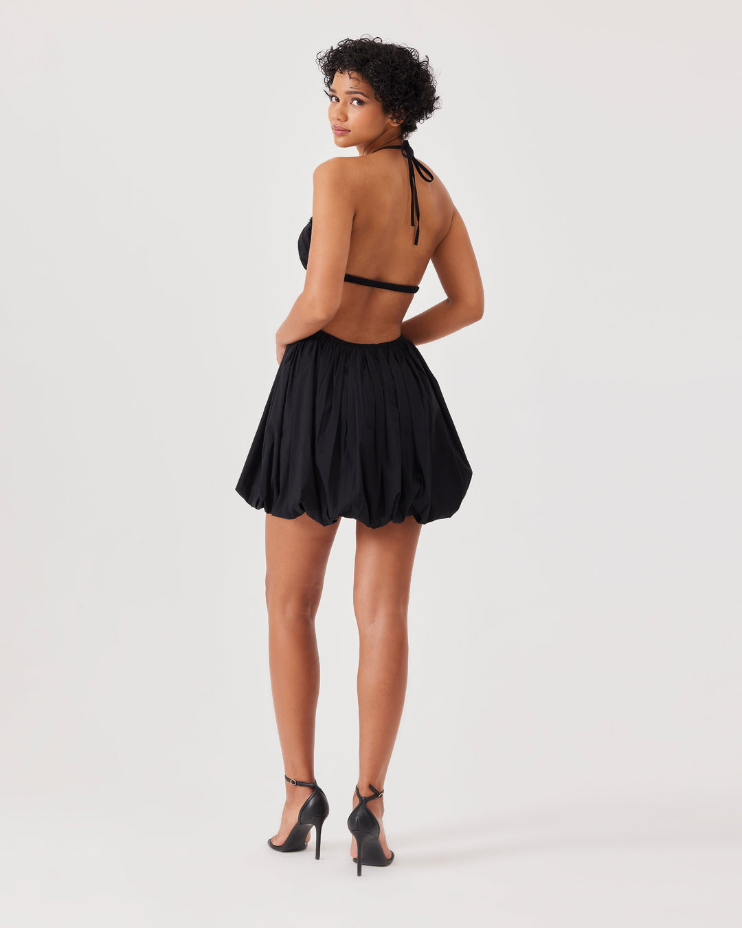 Black, mini dress, poplin, lace details, halterneck, v-neck, sleeveless, open back, balloon skirt, cut-out detail at the waist.