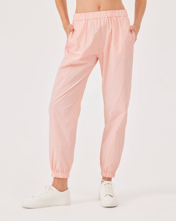 Pink, lightweight running joggers, pants, elastic waistband, parachute fabric, ankle-length, regular fit, side pockets.