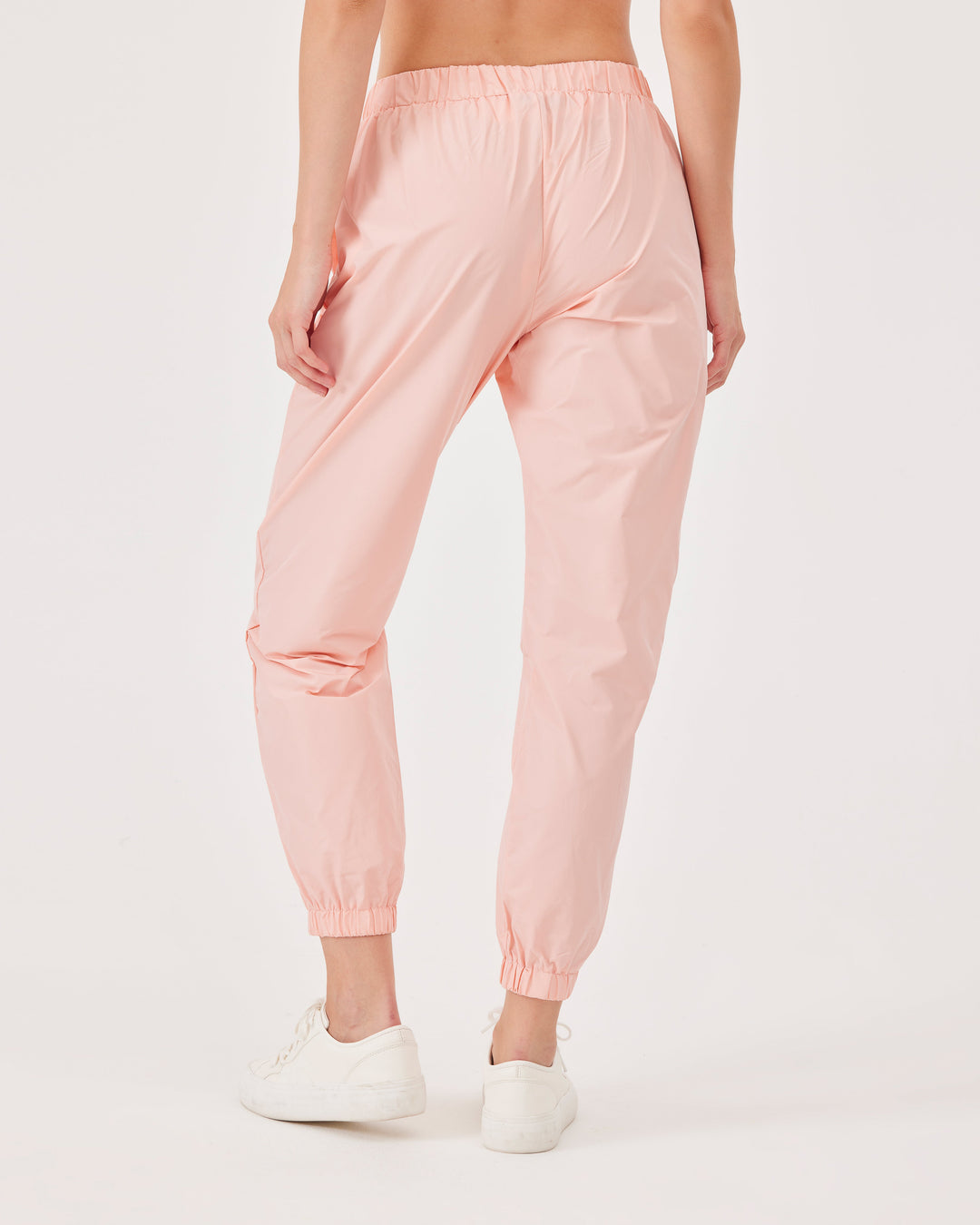 Pink, lightweight running joggers, pants, elastic waistband, parachute fabric, ankle-length, regular fit, side pockets.