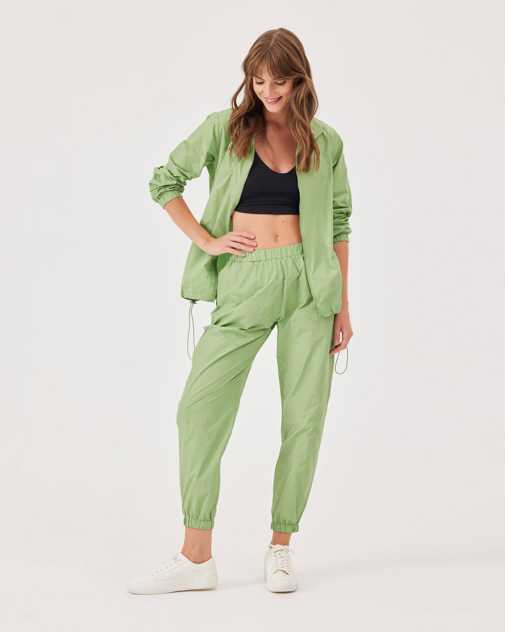 Green, lightweight running joggers, pants, elastic waistband, parachute fabric, ankle-length, regular fit, side pockets.