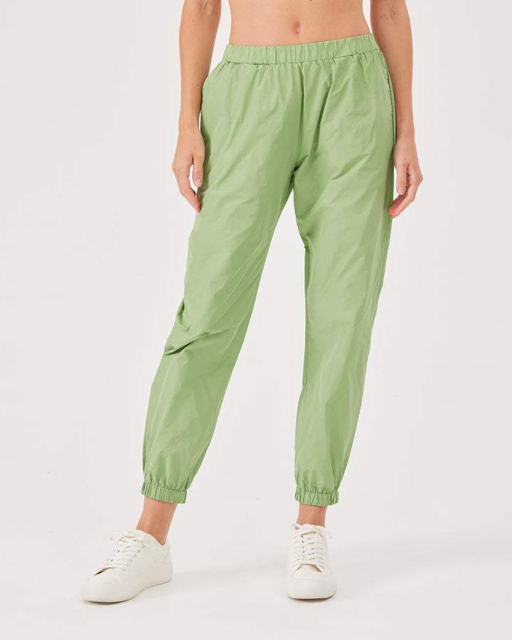 Green, lightweight running joggers, pants, elastic waistband, parachute fabric, ankle-length, regular fit, side pockets.